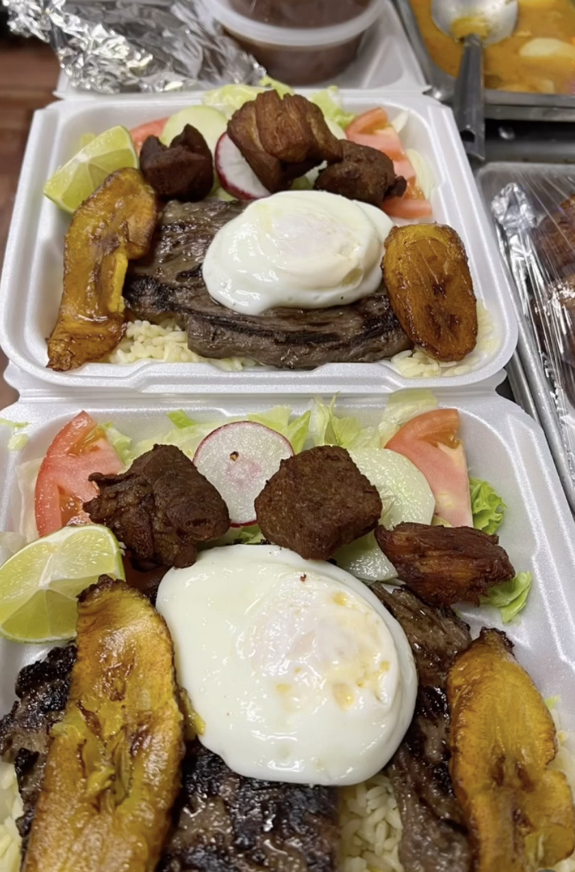 Carne asada plate with fried egg, sweet plantains, chicharrón, rice and salad