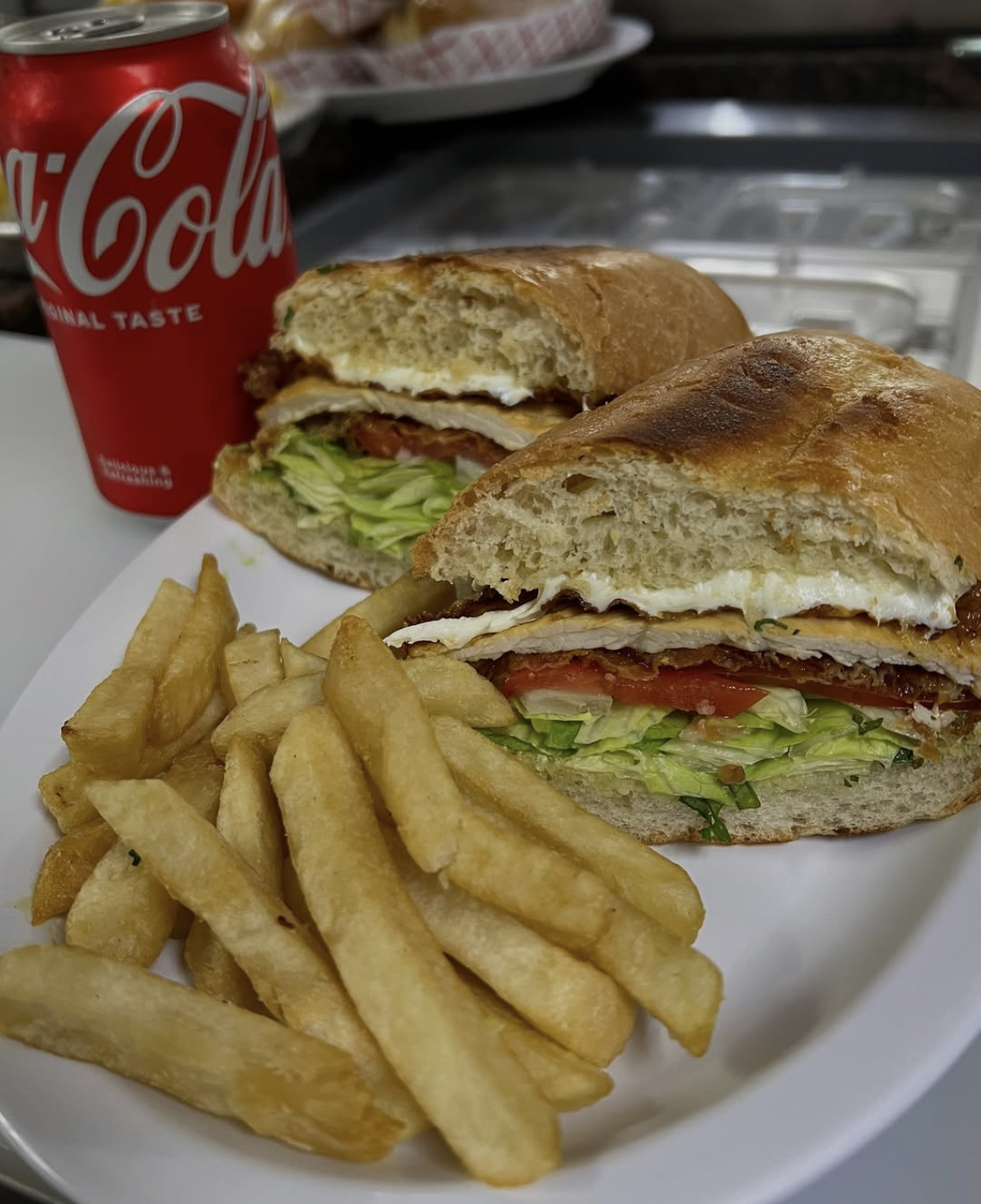 Torta stacked with milanesa, egg, lettuce and tomato, with a side of fries